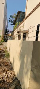 Barbed wire fencing on a house wall by fencing contractors in Chennai