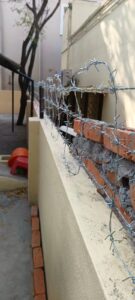 Barbed wire on a brick compound wall in Chennai