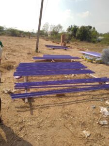 Blue painted fence posts ready for installation