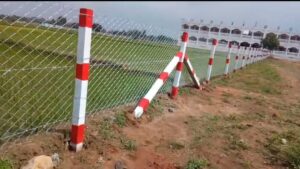 Chain link fencing with red and white poles in Chennai